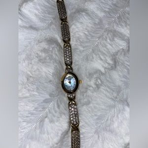 Beautiful gold-tone watch with czs and abalone face.